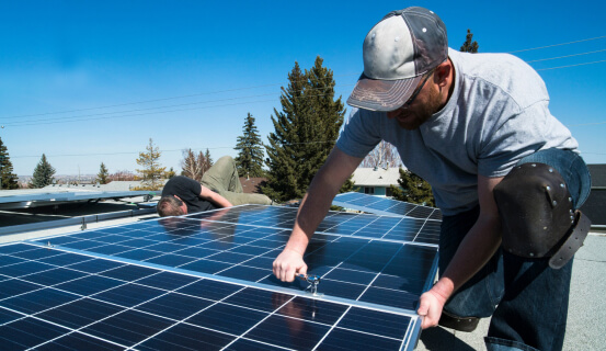 solar pro man installing solar panels on a roof harnessing renewable energy for sustainable power generation