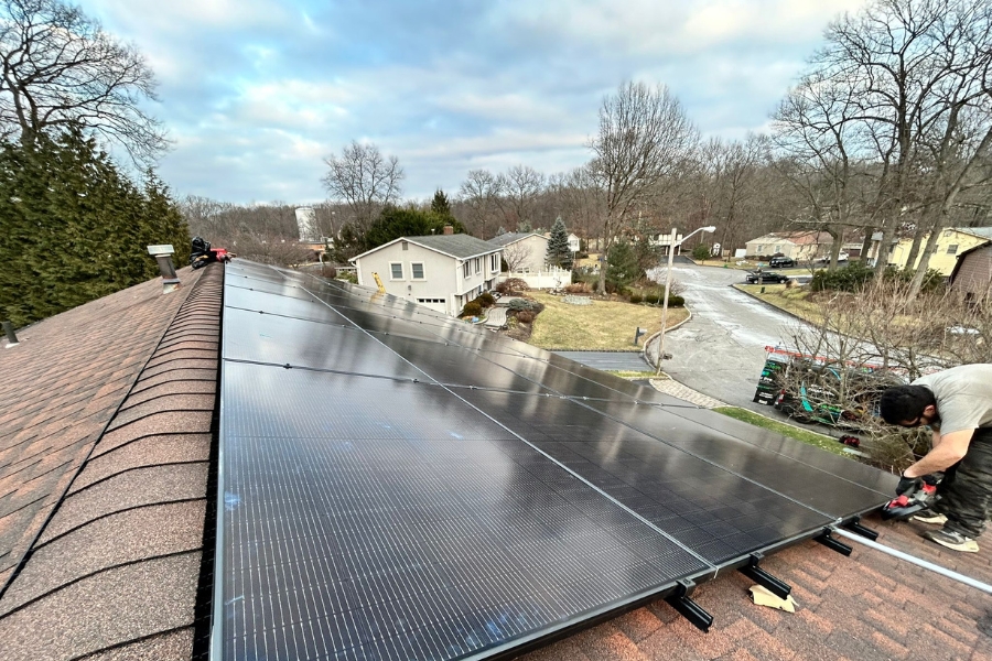 solar pro main tiny home solar panel New York solar panel installer putting up solar panels on a home's roof