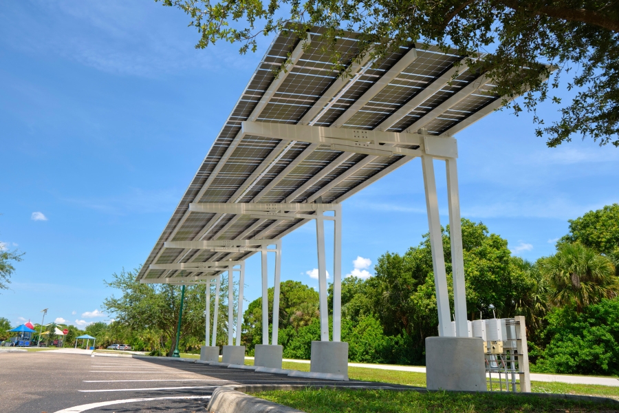 a carport with solar panels on the covering